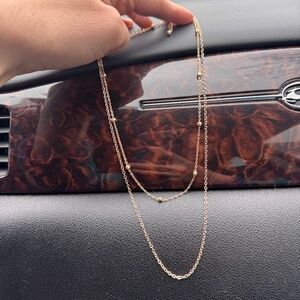 This elegant gold toned layered necklace adds a touch of sophistication to any o